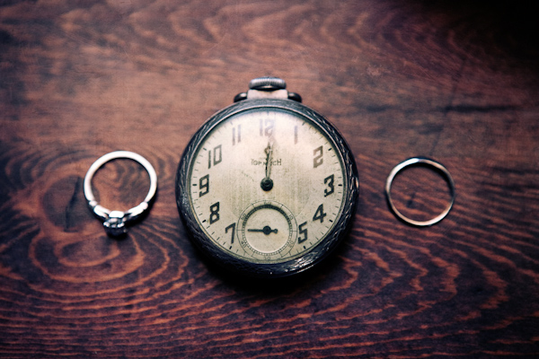 wedding rings displayed next to a pocket watch - photo by Southern California wedding photographers Callaway Gable